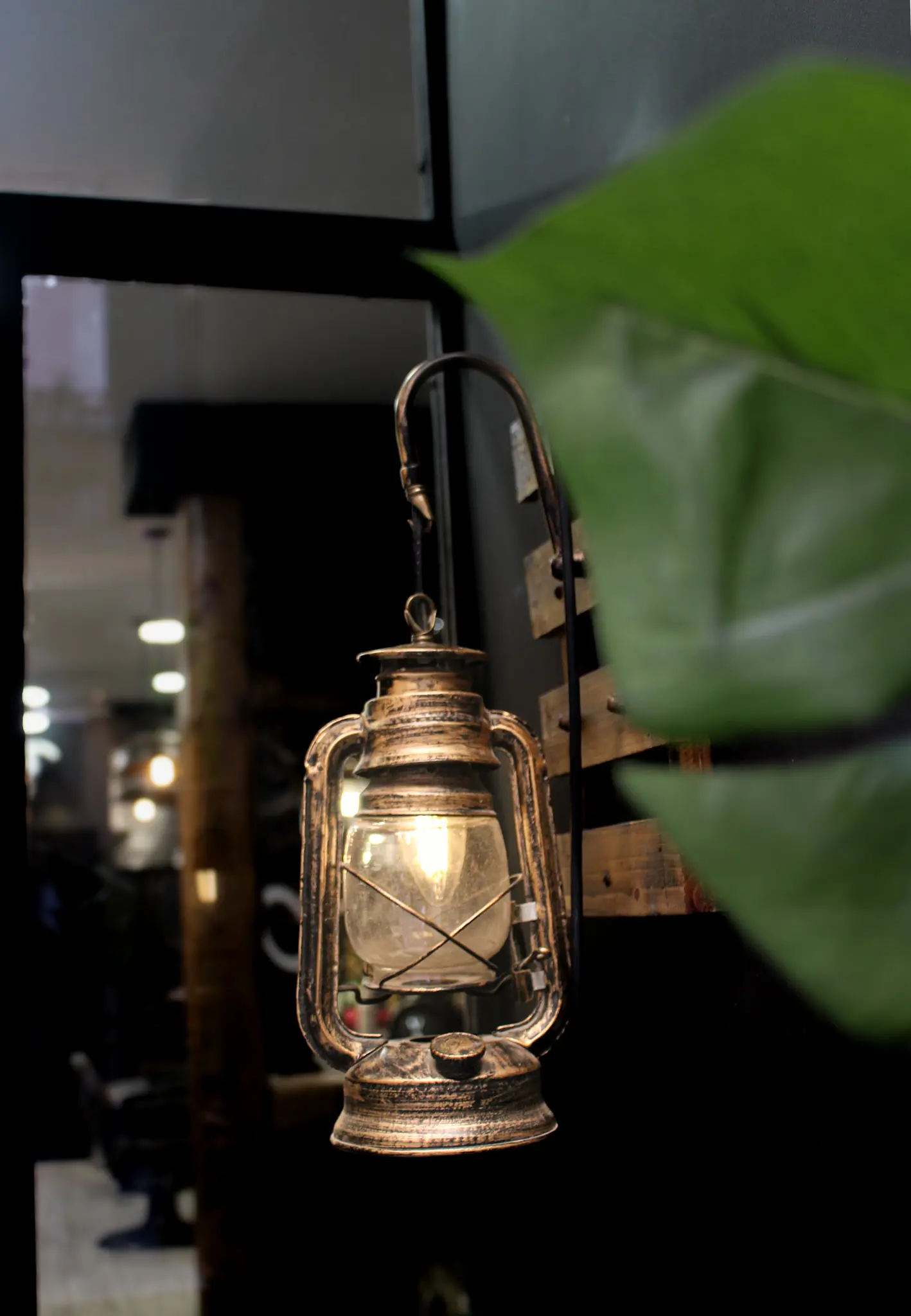 Farol de cobre encendido en la pared del taller